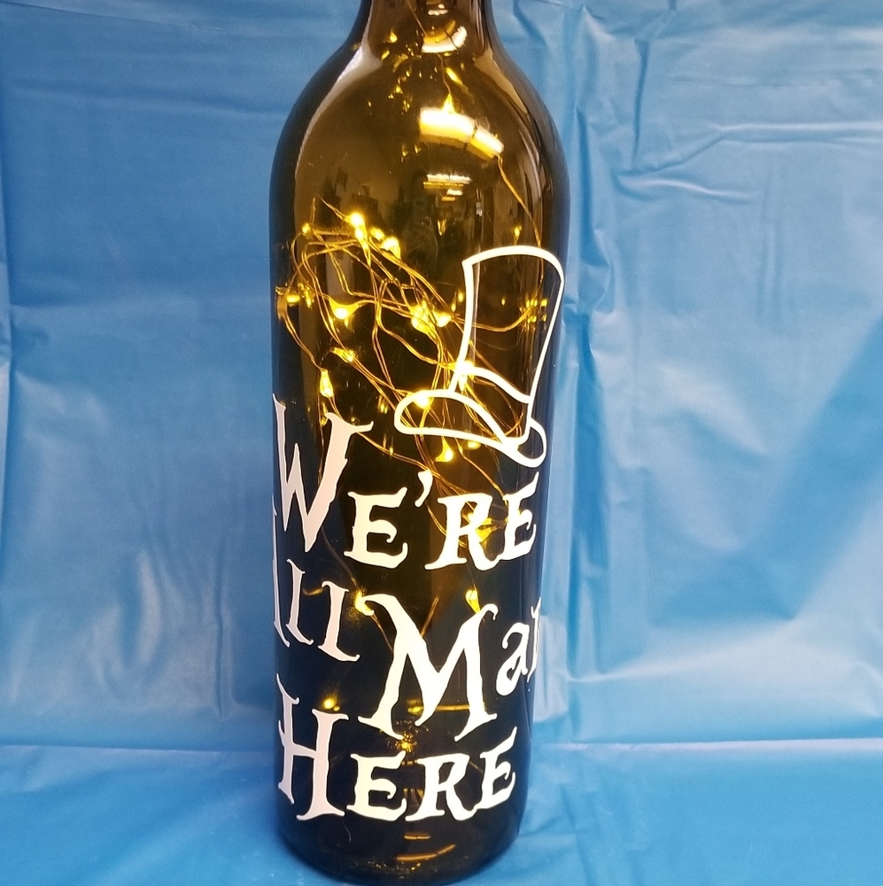 Lighted "We're all mad here" wine bottle
